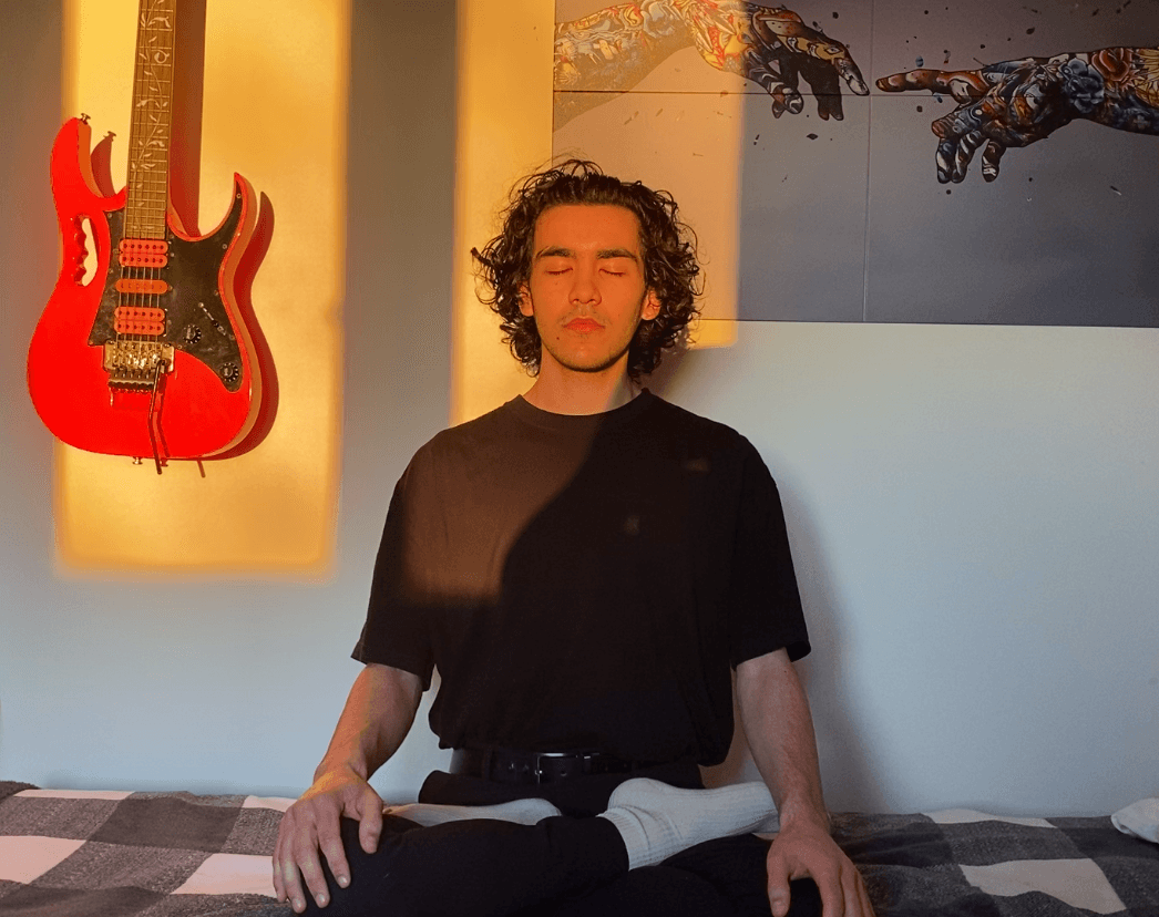 Me sitting in lotus position on my bed in the morning sun.